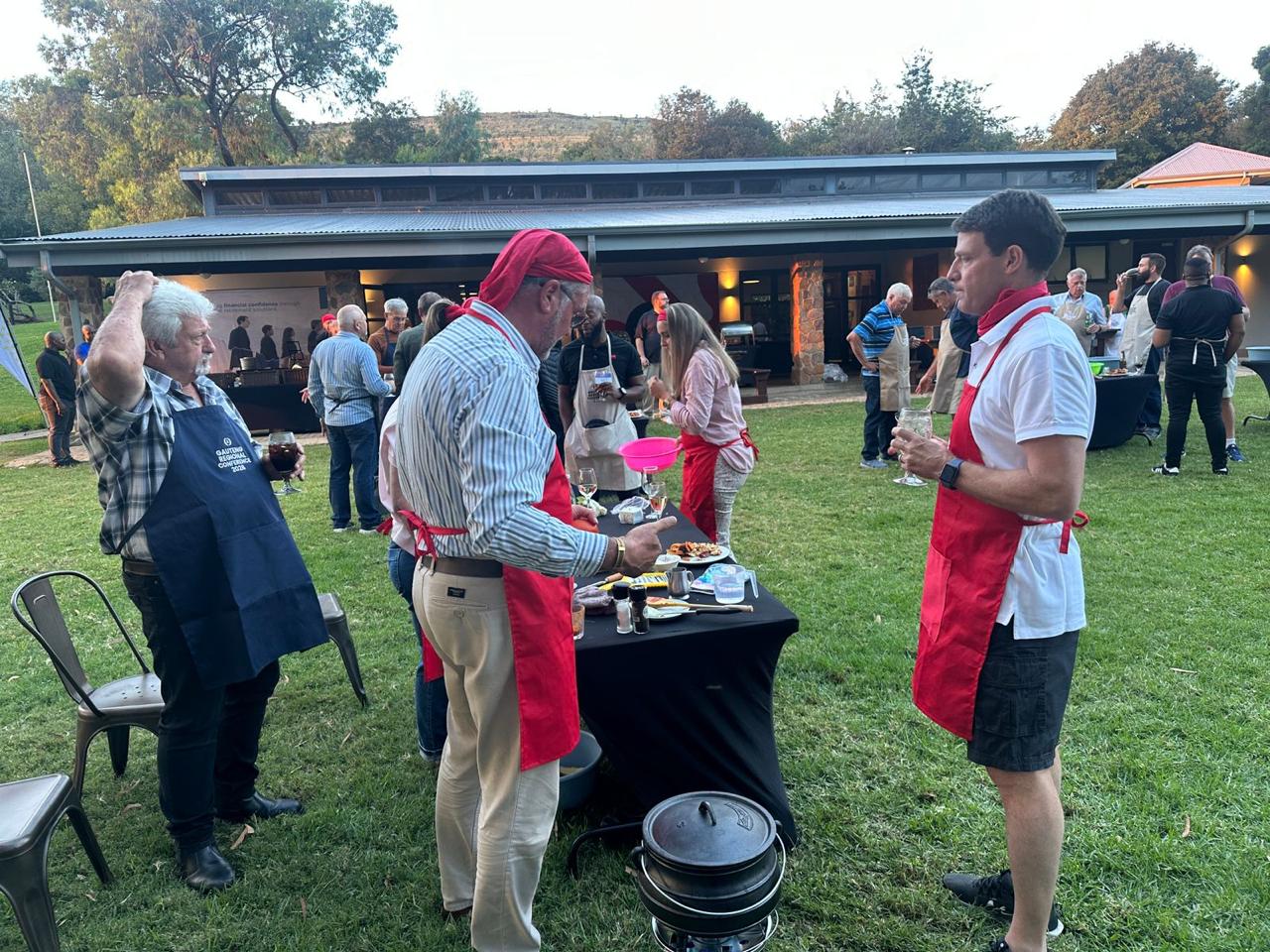 Guests in aprons at an evening potjie cook-off